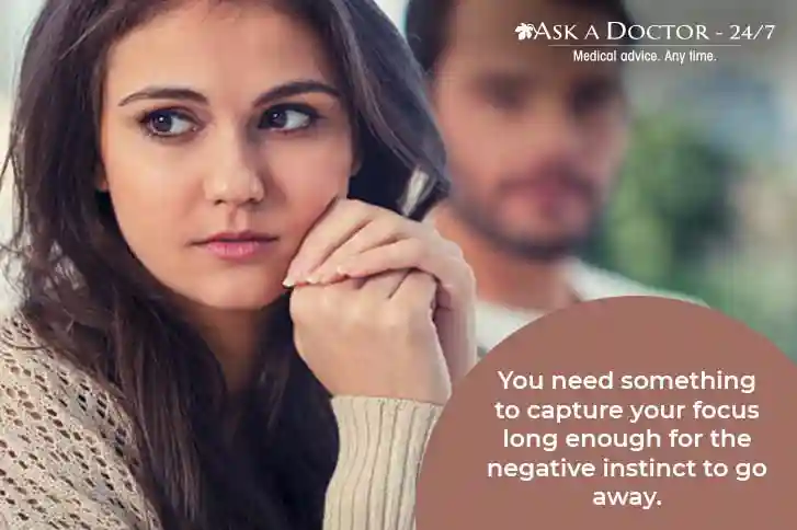 depressed woman sitting with face turned away from husband =